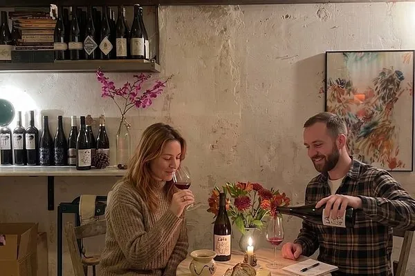 Dos personas catando vino a la luz de las velas, en la mesa de Jugo